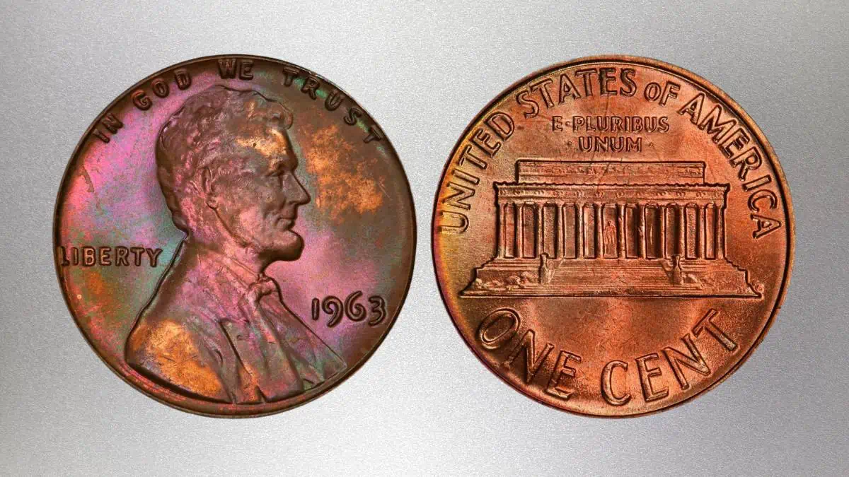 1964 penny overstrike on 1963 Lincoln cent showing ghost Memorial columns behind Lincoln portrait and remnants of 1963 date beneath 1964 strike