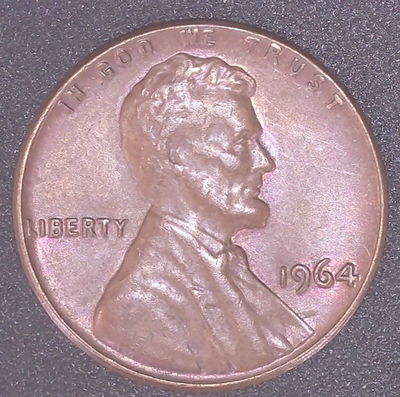 1964 Lincoln penny off-center strike showing partial design with blank copper planchet crescent and full date 1964 visible on struck portion